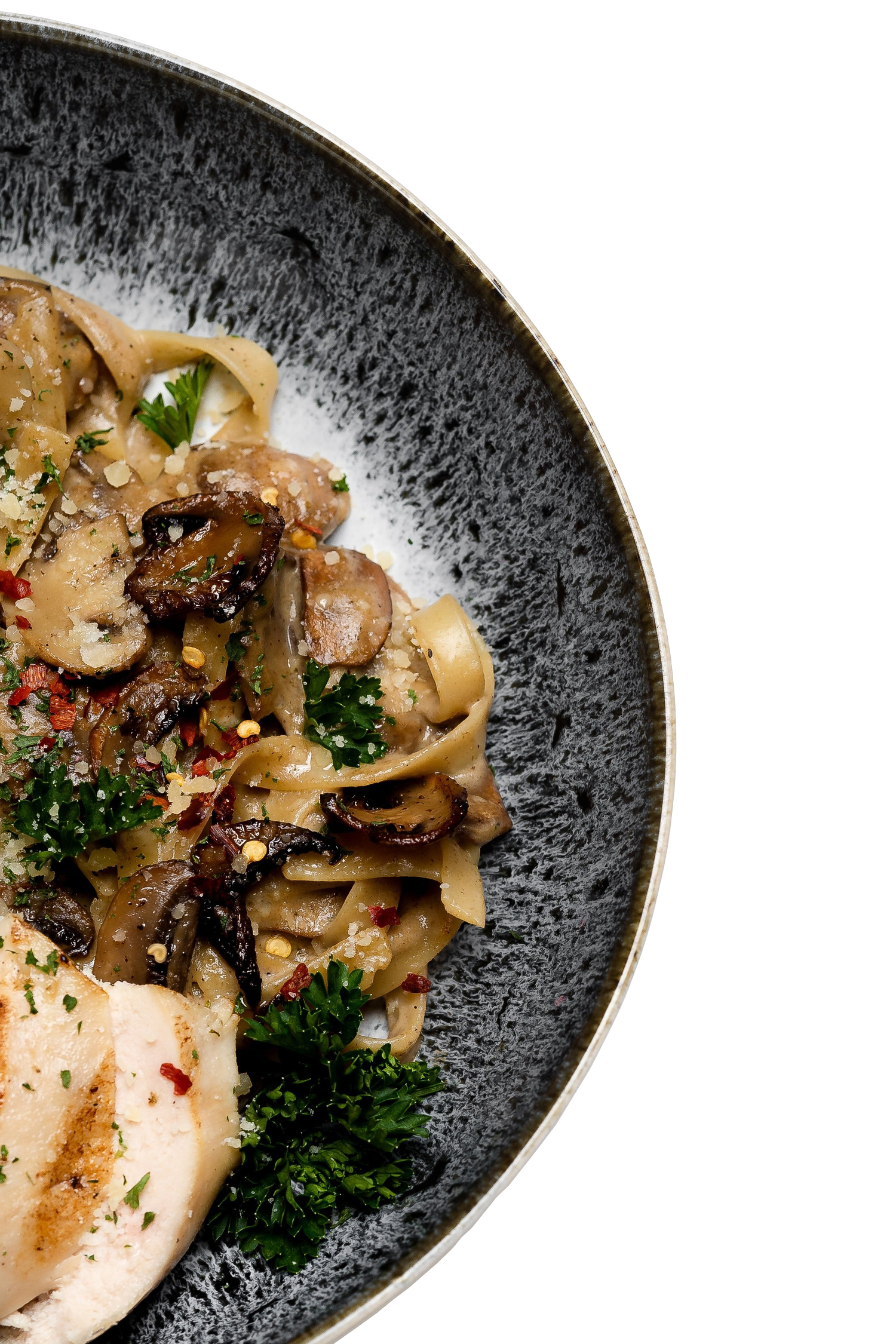 A large plate of pasta with mushrooms and herbs