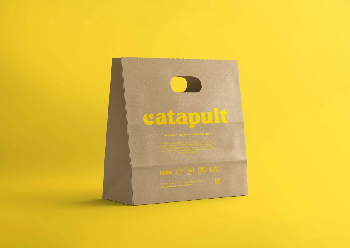 Catapult-branded kraft-paper takeout bag against a yellow background